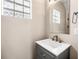 Cozy bathroom featuring modern sink, fixtures, updated vanity, glass block window, and contemporary design at 8426 Foxworth Cir # 44, Orlando, FL 32819