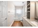Bright bathroom with double vanity, modern fixtures, and glass-enclosed shower at 8426 Foxworth Cir # 44, Orlando, FL 32819