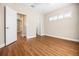 Bright bedroom with wood-look floors and a window with plantation shutters at 8426 Foxworth Cir # 44, Orlando, FL 32819