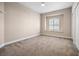 Comfortable bedroom featuring neutral carpet, trim, and window with shutters at 8426 Foxworth Cir # 44, Orlando, FL 32819