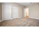 Spacious bedroom featuring neutral carpet, trim, and two large closets at 8426 Foxworth Cir # 44, Orlando, FL 32819