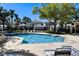 Community pool area with lounge chairs surrounded by lush, manicured landscaping at 8426 Foxworth Cir # 44, Orlando, FL 32819