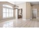 Bright dining room with modern chandelier and large windows featuring white shutters, adjacent to a renovated kitchen at 8426 Foxworth Cir # 44, Orlando, FL 32819