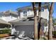 Two story townhouse with an attached garage and a well maintained stucco exterior with landscaping at 8426 Foxworth Cir # 44, Orlando, FL 32819