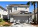Charming two-story home featuring a tile roof, an attached two car garage, and meticulously maintained landscaping at 8426 Foxworth Cir # 44, Orlando, FL 32819