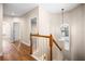 Hallway with wood floors, a wood and white staircase, and neutral walls at 8426 Foxworth Cir # 44, Orlando, FL 32819