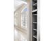 Hallway with arched windows, white shutters, and built-in shelves for storage and decor at 8426 Foxworth Cir # 44, Orlando, FL 32819