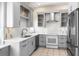 Modern kitchen with stainless steel appliances, gray cabinetry, white countertops and stylish backsplash at 8426 Foxworth Cir # 44, Orlando, FL 32819
