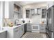 Modern kitchen with stainless steel appliances, gray cabinetry, white countertops and stylish backsplash at 8426 Foxworth Cir # 44, Orlando, FL 32819