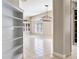 Spacious living room with tiled floor, white shutters, modern chandelier and a view to built-in shelves at 8426 Foxworth Cir # 44, Orlando, FL 32819