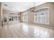 Expansive living room featuring neutral tile flooring, a modern light fixture, and lots of natural light at 8426 Foxworth Cir # 44, Orlando, FL 32819