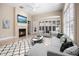 Cozy living room with a fireplace, large windows, and stylish neutral-toned furniture at 8426 Foxworth Cir # 44, Orlando, FL 32819