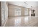 Expansive living room featuring neutral tile flooring, a modern light fixture, and lots of natural light at 8426 Foxworth Cir # 44, Orlando, FL 32819