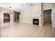 Spacious living room features tile flooring, fireplace, ceiling fan, and modern light fixture at 8426 Foxworth Cir # 44, Orlando, FL 32819