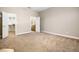 Bright bedroom with neutral walls and carpet, leading to a bathroom and closet at 8426 Foxworth Cir # 44, Orlando, FL 32819