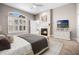 Inviting main bedroom with fireplace, large window and white shutters, providing comfort and natural light at 8426 Foxworth Cir # 44, Orlando, FL 32819