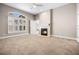 Spacious main bedroom featuring a fireplace, ceiling fan, neutral carpet, and shuttered windows at 8426 Foxworth Cir # 44, Orlando, FL 32819