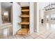 View of pull-out pantry shelves, hallway, and fireplace, with abundant space for food and kitchen supplies at 8426 Foxworth Cir # 44, Orlando, FL 32819