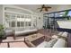 Screened patio with brick flooring, ceiling fan, and comfortable outdoor furniture at 8426 Foxworth Cir # 44, Orlando, FL 32819