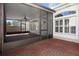 Spacious screened patio area with brick flooring and access to the outdoors at 8426 Foxworth Cir # 44, Orlando, FL 32819