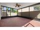 Open screened patio with brick flooring, ceiling fan, and views of lush greenery at 8426 Foxworth Cir # 44, Orlando, FL 32819