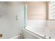 Corner bathtub with glass enclosure and a gold shower fixture at 8426 Foxworth Cir # 44, Orlando, FL 32819