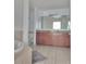 This spacious bathroom offers double sinks, a garden tub, and tile flooring at 8763 Worldquest Blvd # 5103, Orlando, FL 32821