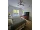Comfortable bedroom with a queen bed, window, and dresser, offering a cozy and inviting space at 8763 Worldquest Blvd # 5103, Orlando, FL 32821