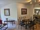 Stylish dining area featuring a glass table with seating, complemented by artwork and modern decor at 8763 Worldquest Blvd # 5103, Orlando, FL 32821