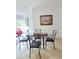 Cozy dining area featuring a glass-top table with seating for four, bathed in natural light at 8763 Worldquest Blvd # 5103, Orlando, FL 32821