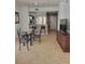 Open dining area with a glass table, seating for four, and tiled floors leading into the kitchen at 8763 Worldquest Blvd # 5103, Orlando, FL 32821