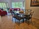 Bright dining area with glass-top table and seating, flowing into a comfortable living space with red sofa at 8763 Worldquest Blvd # 5103, Orlando, FL 32821