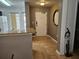Condo entryway with granite counter, gray walls, tile flooring, and a decorative mirror at 8763 Worldquest Blvd # 5103, Orlando, FL 32821