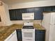 A well-equipped kitchen with modern white appliances, granite countertops, and dark cabinets at 8763 Worldquest Blvd # 5103, Orlando, FL 32821
