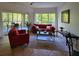 Bright living room featuring a comfortable sofa, large windows, and access to a screened patio at 8763 Worldquest Blvd # 5103, Orlando, FL 32821