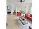 Comfortable living room featuring tiled floors, leading to a screened patio and bedroom at 8763 Worldquest Blvd # 5103, Orlando, FL 32821