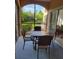 Relaxing screened patio with outdoor dining set and view of lush greenery, perfect for outdoor enjoyment at 8763 Worldquest Blvd # 5103, Orlando, FL 32821