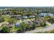 Stunning aerial view of community featuring lush landscaping, mature trees, and a lake at 907 Almond Tree Cir, Orlando, FL 32835