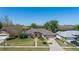 Aerial view of a single-story home with mature landscaping, a well-kept lawn, and a two-car garage at 907 Almond Tree Cir, Orlando, FL 32835
