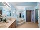 Bathroom featuring a large jacuzzi tub with a shower and white flower accents at 907 Almond Tree Cir, Orlando, FL 32835