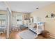 Cozy bedroom featuring wood laminate floors, a crib, and lots of natural light at 907 Almond Tree Cir, Orlando, FL 32835