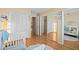 Bright bedroom with wood floors, mirrored closet doors, and a comfy sitting area at 907 Almond Tree Cir, Orlando, FL 32835