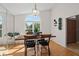Dining room featuring a large arched window, hardwood floors, and a stylish light fixture at 907 Almond Tree Cir, Orlando, FL 32835