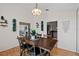Dining room featuring hardwood floors, modern light fixture, and a view to the living room and kitchen at 907 Almond Tree Cir, Orlando, FL 32835
