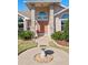 Inviting front entrance with a walkway leading to a double front door and a decorative bird bath at 907 Almond Tree Cir, Orlando, FL 32835