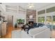 Bright living room features a brick fireplace, built-in shelving, and sliding glass doors to the backyard at 907 Almond Tree Cir, Orlando, FL 32835