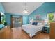 Main bedroom with laminate flooring, a vaulted ceiling, and sliding glass doors at 907 Almond Tree Cir, Orlando, FL 32835