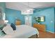 Bright main bedroom with en-suite access features french doors, hard floors, and ceiling fan at 907 Almond Tree Cir, Orlando, FL 32835