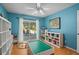 Spacious playroom with a ceiling fan, laminate flooring, and sliding doors to the outside at 907 Almond Tree Cir, Orlando, FL 32835