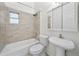 Bathroom with tile backsplash, shower and tub combination, and sleek vanity at 908 Cannes Pl, Orlando, FL 32808